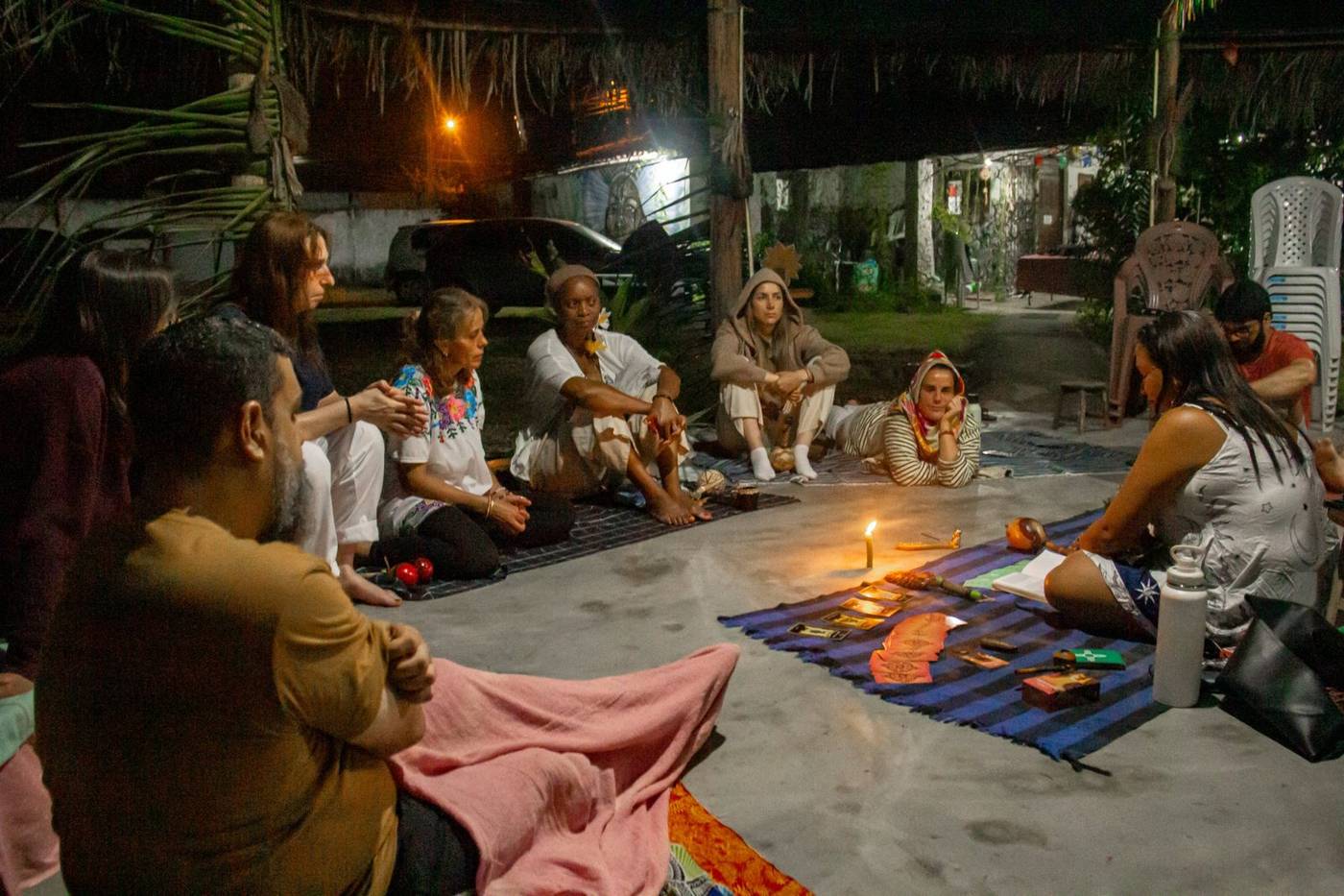 Círculo nocturno del grupo alrededor de una vela